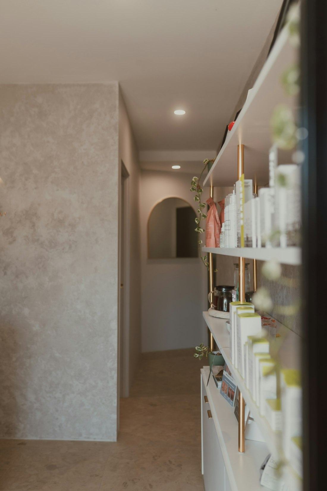 Bright studio hallway with skincare shelves